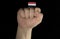 Man hand fist with Yemeni flag isolated on black background