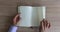 Man hand flips through blank pages of notebook