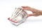 Man hand grabbing Japanese 10000 banknote in shopping basket on white background