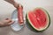 Man hand hold from on fresh watermelon cutting for eatin on table background
