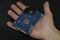 Man hand hold an hdd memory storage device over dark surface,tech components,data security parts