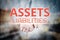 Man hand holding Assets Liabilities text on blurry home icon pro