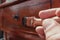 Man hand holding a brush applying varnish paint on a wooden surface. Concept protect  and renovate the wood