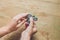 A man hand holding hand spinner or fidget spinner over wooden background