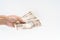 Man hand holding Japanese 10000 banknote on white background