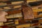 Man hand holding a mallet hammer made of burl wood tools for used by carpenter in workshop on blurred background