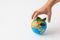 Man hand holding object Earth isolated on white background. Save Earth concept. Ecology. Green planet. danger to the