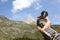 Man hand holding an orientation compass with beautiful mountain scenery on the background with copy space for your text