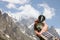 Man hand holding an orientation compass with beautiful mountain scenery on the background with copy space for your text