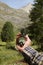 Man hand holding an orientation compass with beautiful mountain scenery on the background with copy space for your text