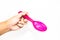 Man hand is holding the pink color of plastic long spoon