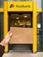 Man hand holding postal envelope in front of Postbank postal office in German city POV personal perspective
