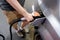 A man hand holding pump filling gasoline. Pumping petrol into the tank.