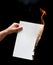 Man hand holding white burned paper