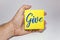 man hand holding a yellow note paper with the text give against white background - Charity Concept