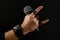 Man hand with microphone isolated on black