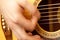 Man hand playing acoustic guitar strings recreation concept