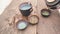 Man hand pours green Chinese tea into clay cups which stand on mahogany planks