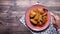 Man hand preparing indian fish curry on plate.