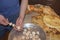 Man hand put raw mushrooms and courgette vegetable pieces on skewer