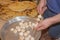 Man hand put raw mushrooms and courgette vegetable pieces on skewer