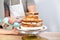 Man hand put whipped cream on the cake crust, Close shot of a human hand frosting a cake with whipped cream on the