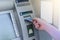 Man hand puts card, press button gray ATM