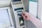 Man hand puts card, press button gray ATM