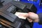 Man hand putting banknotes in the receiver of the cash recycler, close-up