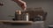 man hand salting bopiling water for pasta in saucepan closeup