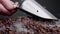 Man hand scooping coffee grains using ladle close up. Person mixing seeds.