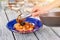 Man hand serving italian pasta with mussel.