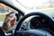 Man hand spraying alcohol sanitizer on steering wheel in his car, Corona Virus Disease Covid 19. Antiseptic, Hygiene and