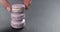 Man hand stacking lavender macarons on slate board