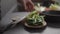 Man hand take chopped romaine lettuce from wood board to make salad