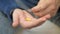 Man hand take pills from blister pack. Close up of male hand pour white orange round tablet. Medicament dose pill in hand. Flu sic