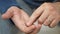 Man hand take pills from blister pack. Close up of male hand pour white orange round tablet. Medicament dose pill in hand. Flu sic