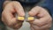 Man hand take pills from blister pack. Close up of male hand pour white orange round tablet. Medicament dose pill in hand. Flu sic