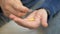 Man hand take pills from blister pack. Close up of male hand pour white orange round tablet. Medicament dose pill in hand. Flu sic