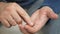 Man hand take pills from blister pack. Close up of male hand pour white orange round tablet. Medicament dose pill in hand. Flu sic