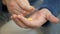 Man hand take pills from blister pack. Close up of male hand pour white orange round tablet. Medicament dose pill in hand. Flu sic