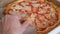 Man hand takes delicious colorful pizza slice close view