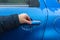 Man hand trying to open freezing car door handle, Hand on Car`s door handle after a freezing rain