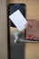 Man hand use key card switch in to open hotel room door