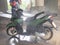 Man hand used red injection machine and wash green Motorbike