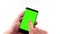 Man hand using a smart phone with chroma key on white background, green screen