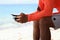 Man hand which texting on smart phone on the beach