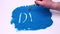 Man hand writing word Diet on a blue art sand. Studio footage on a white background.