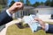 Man Handing a man Thousands of Dollars For Keys in Front of House.