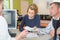 Man handing social security card to hospital receptionist